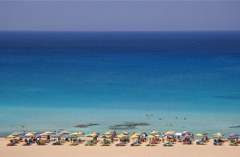 Umbrellas on the beach and emerald seas at Phalassarna (Falassarna) in Western Crete, Greece, Europe