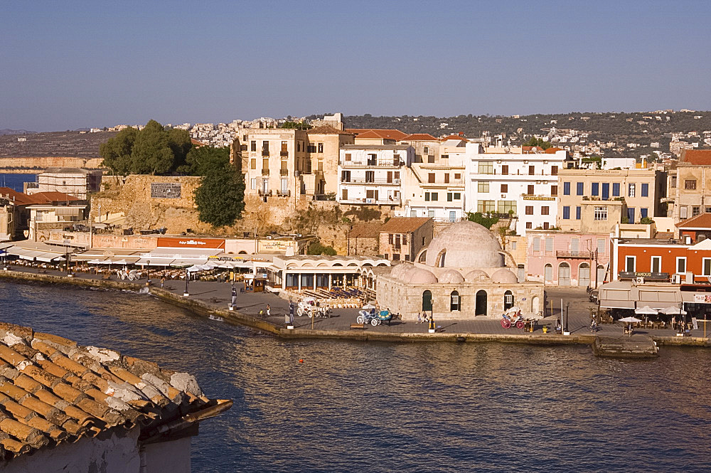 A view of tavernas around the harbour and the Kutchuk Hasan Mosque in the old town section of Hania, Crete, Greek Islands, Greece, Europe