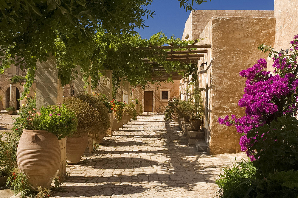 Terracotta urns and flowers in the cloister at Arkadhi Monastery (Moni Arkadhi), twenty-five miles from Rethymnon, Crete, Greek Islands, Greece, Europe