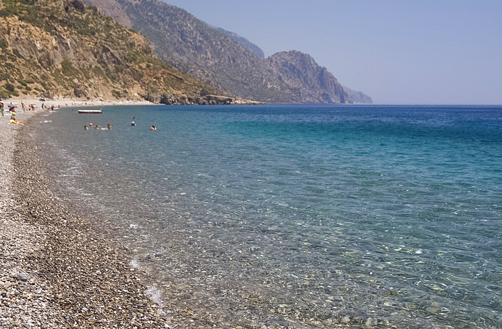 The pebble beach and emerald seas at Sougia on the south coast of Crete, Greek Islands, Greece, Europe