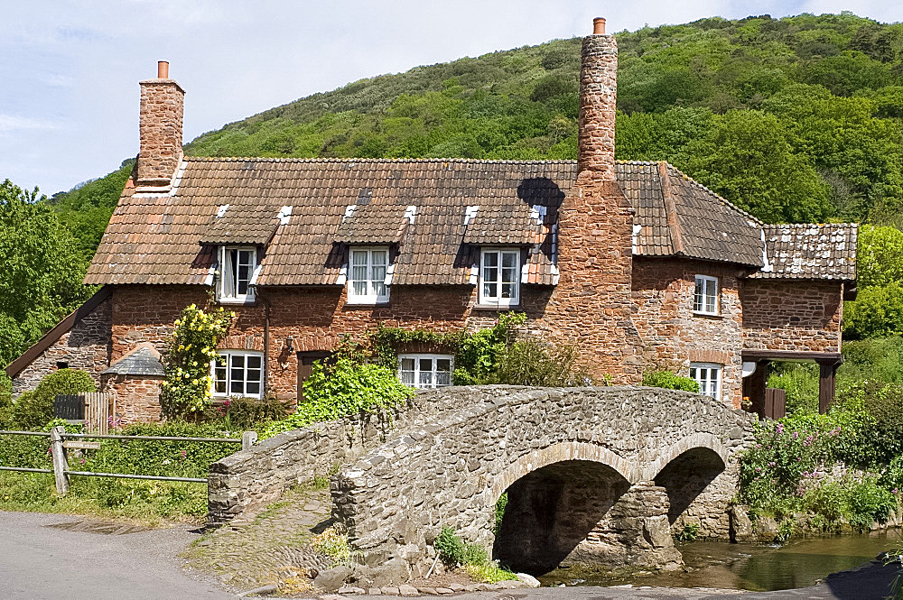 An old stone house with round chimney and stone bridge in Allerford, Exmoor National Park, Somerset, England, United Kingdom, Europe