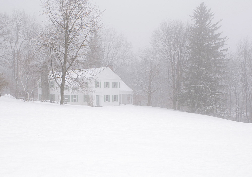 A traditional wooden house with shutters during a snow storm in upstate New York, Rensselaerville, New York State, United States of America, North America