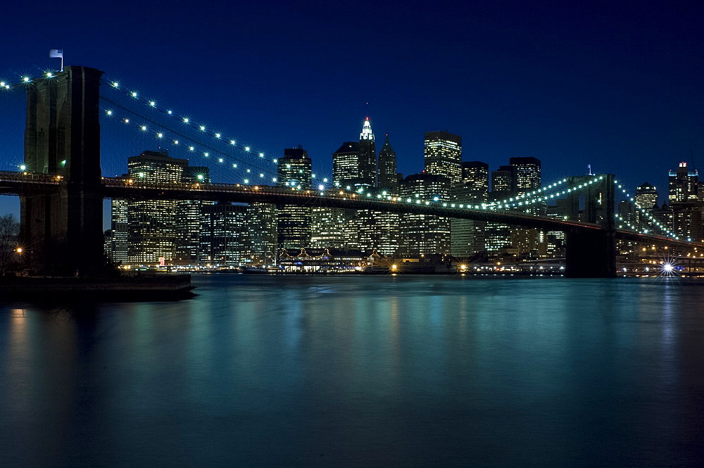 The Brooklyn Bridge and the Manhattan skyline at dusk, New York City, New York State, United States of America