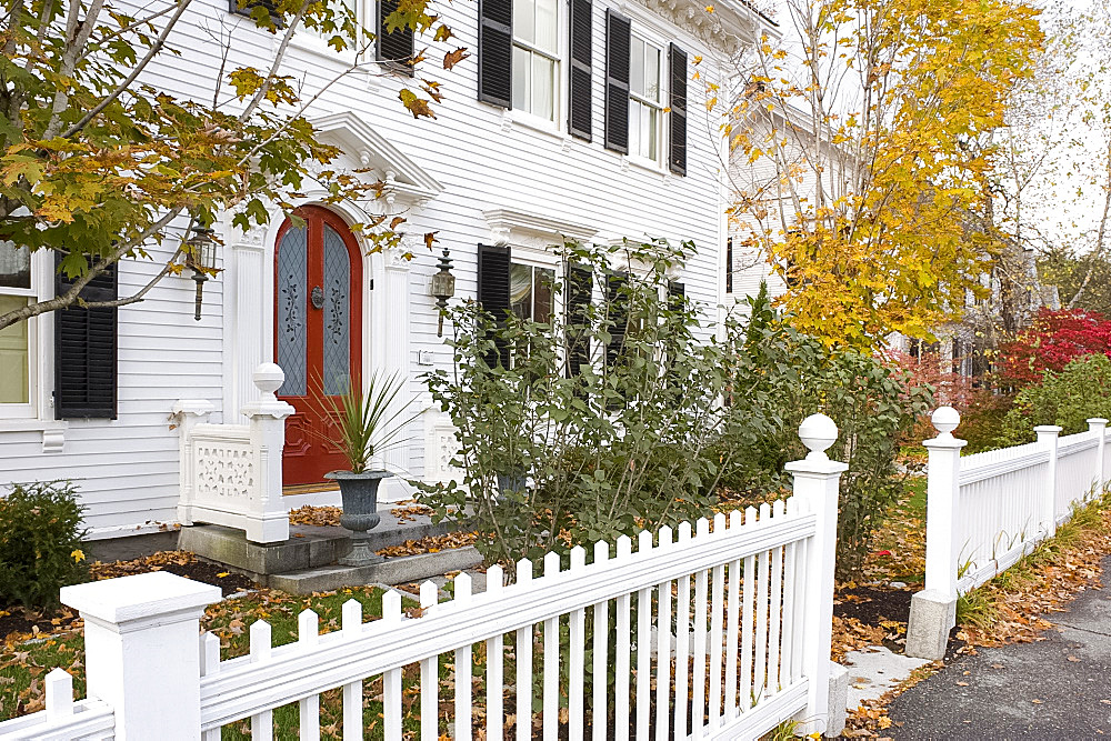 A traditional wood house and picket fence surrounded by autumn leaves in Woodstock, Vermont, New England, United States of America, North America