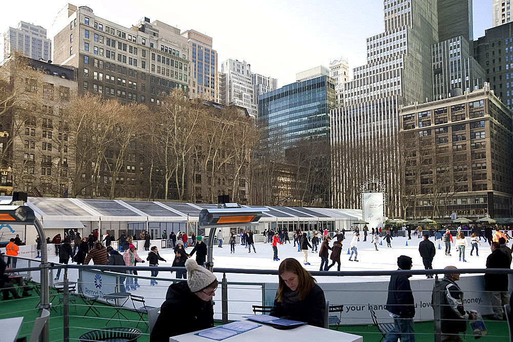 People sitting in a cafe next to the skating rink in Bryant Park, New York City, New York State, United States of America, North America