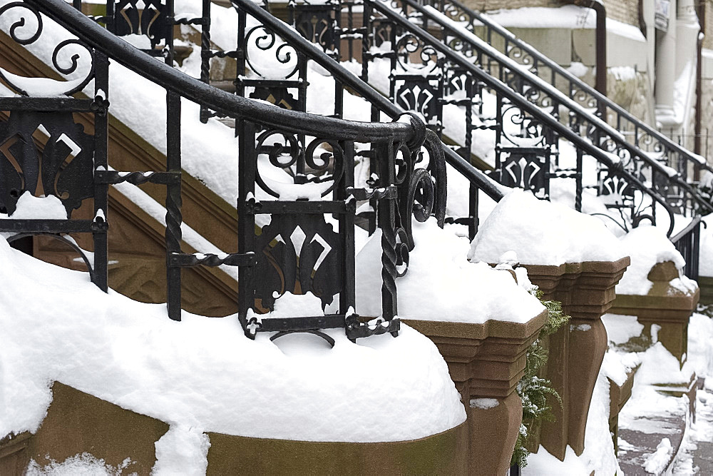 Snow on the iron railings of brownstone houses on the upper west side of Manhattan, New York City, New York State, USA