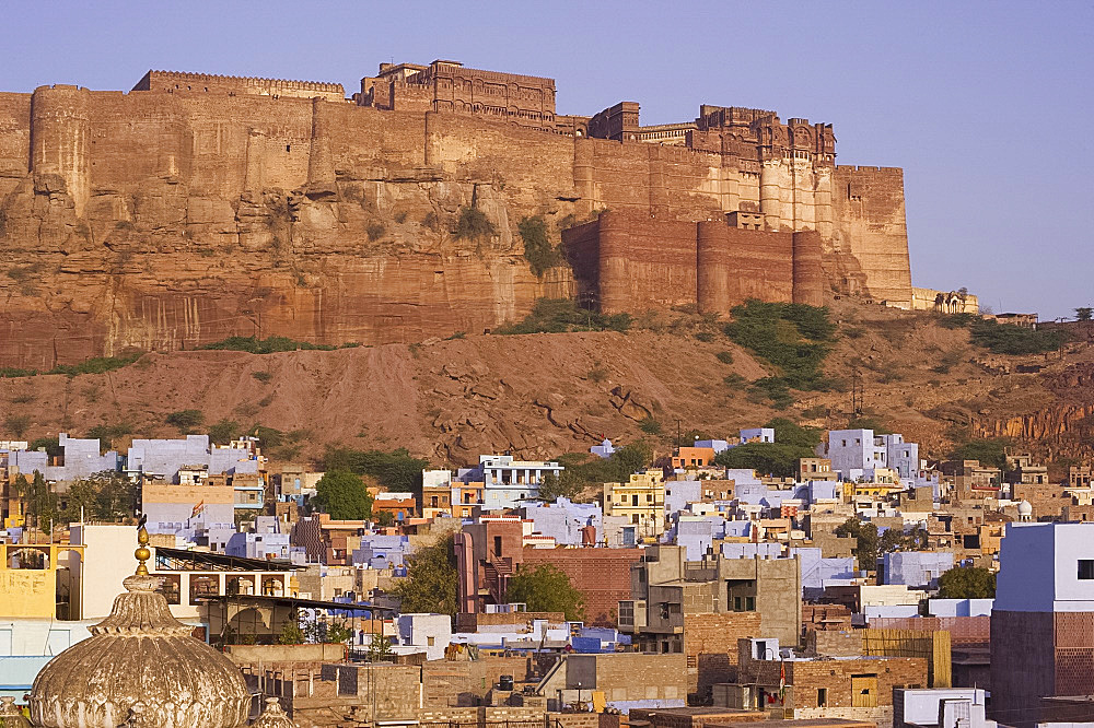 The Mehrangarh Fort on a hilltop overlooking the blue houses of Jodhpur, Rajasthan, India, Asia