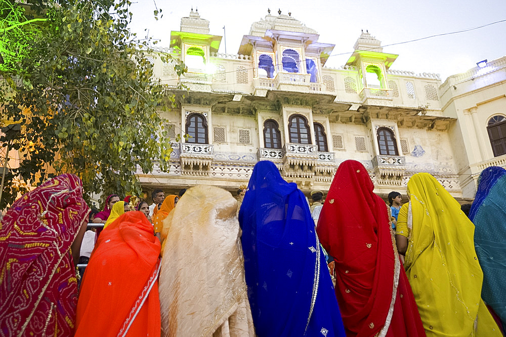 Women wearing colourful saris at the Mewar Festival on Lake Pichola, Udaipur, Rajasthan, India, Asia