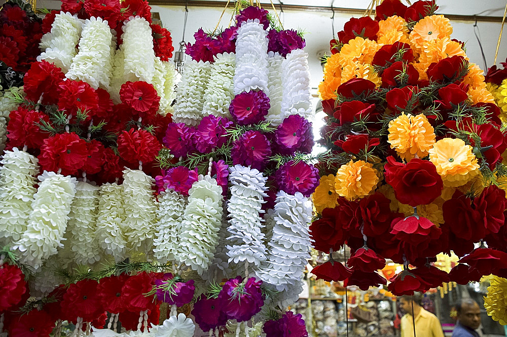 Garlands of colourful artificial flowers for sale in the market in Old Delhi, India, Asia