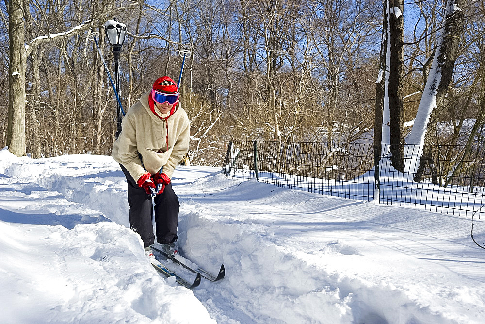 A woman on cross country skis in Central Park after a blizzard, New York City, New York State, United States of America, North America