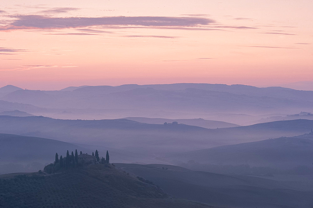 A dawn view over the misty hills of Val d'Orcia and the Belvedere, San Quirico d'Orcia, UNESCO World Heritage Site, Tuscany, Italy, Europe