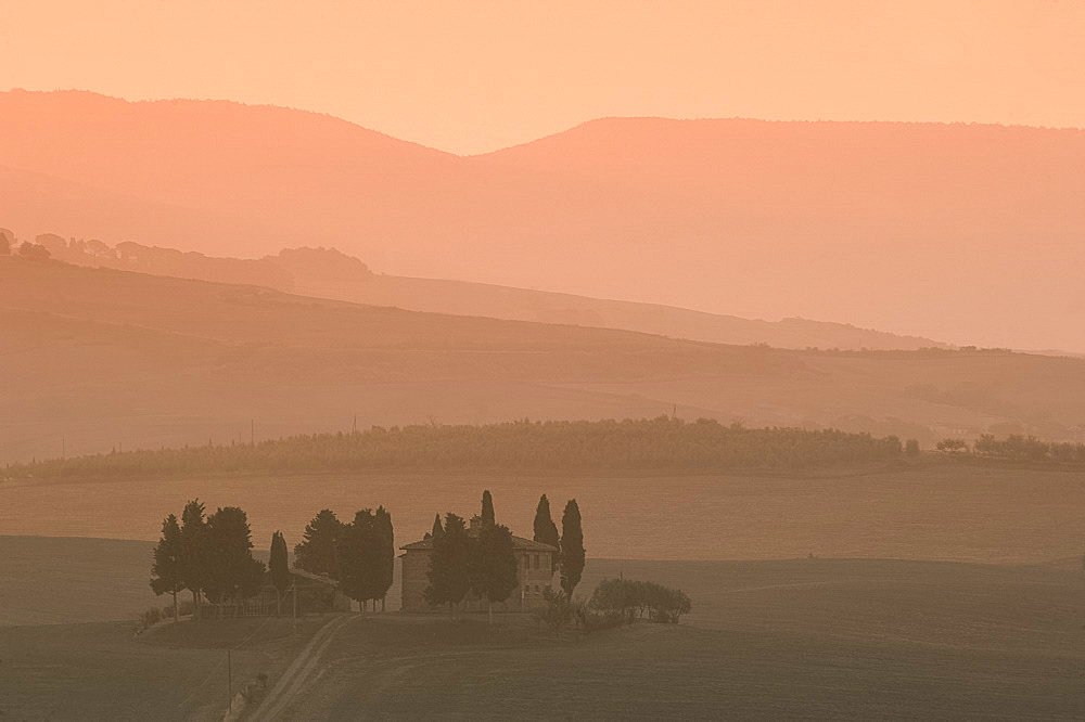 Dawn at Penella, a farmhouse surrounded by cypress trees and the misty hills of Val d'Orcia near Pienza, UNESCO World Heritage Site, Tuscany, Italy, Europe