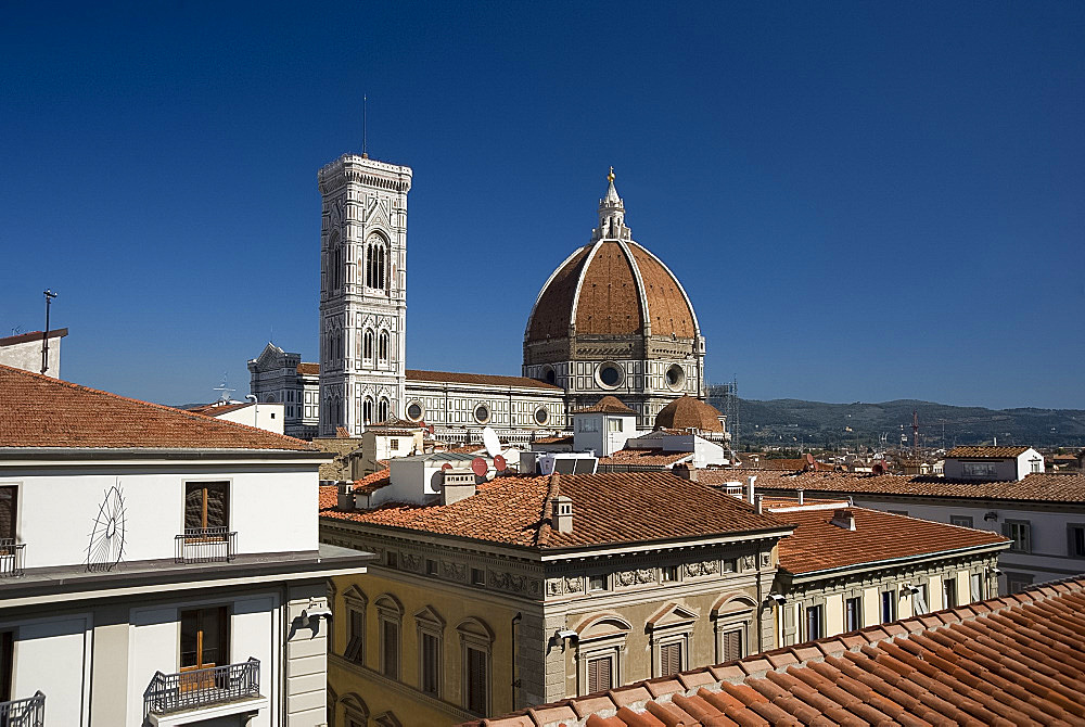 A view over teracotta rooftops to the Duomo and Campanile, Florence, UNESCO World Heritage Site, Tuscany, Italy, Europe