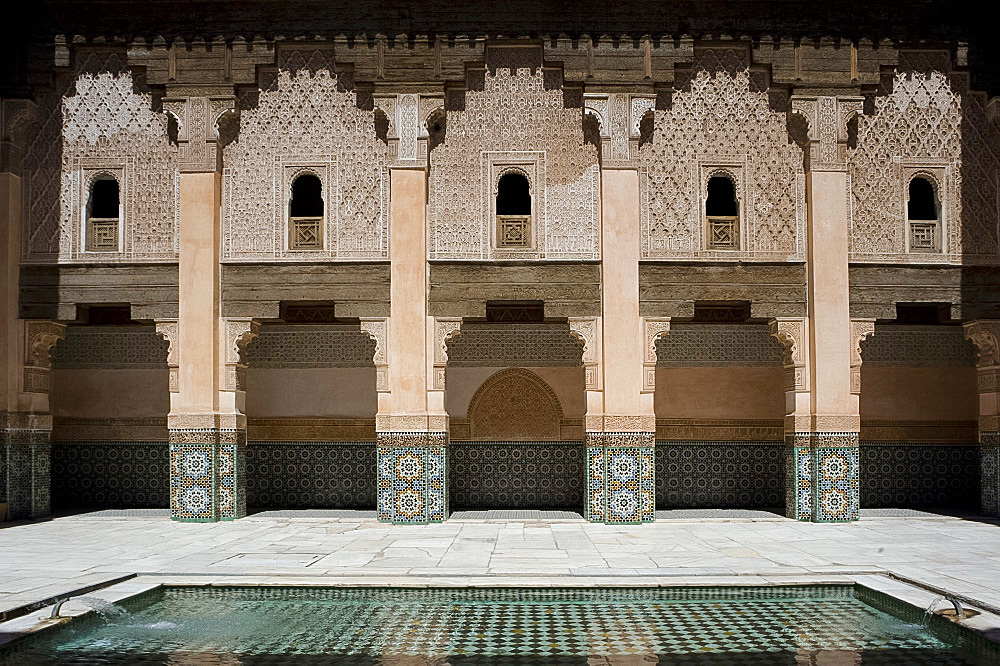 A tiled interior courtyard and reflecting pool at the Ben Youssef Madrassa, Marrakech, Morocco, North Africa, Africa