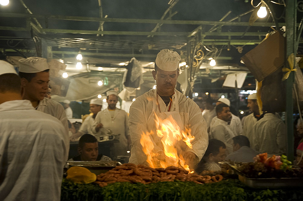 A chef grilling meat at one of the many nightly food stalls in the main square, Jemaa el Fna, in Marrakech, Morocco, North Africa, Africa