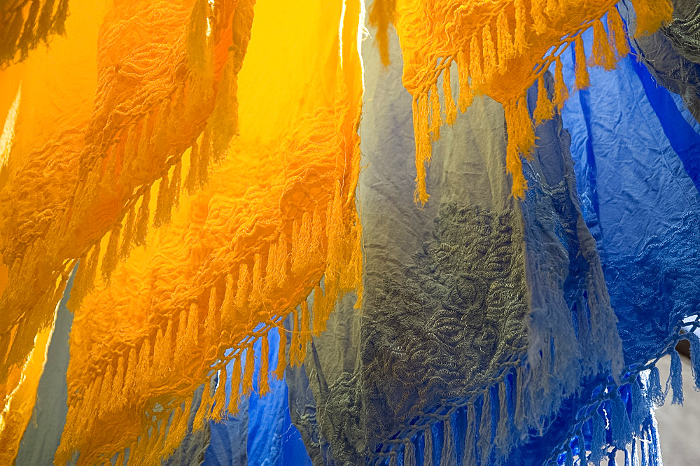 Brightly coloured dyed fabrics hanging to dry in the dyers souk, Marrakech, Morocco, North Africa, Africa