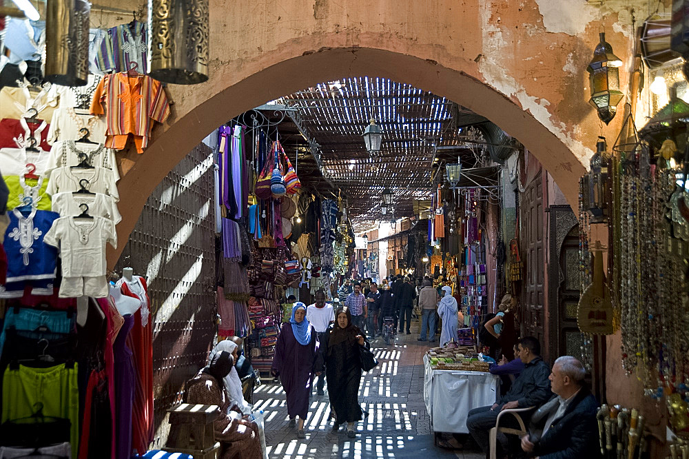 The view through an arch of shoppers in the souk in Marrakech, Morocco, North Africa, Africa