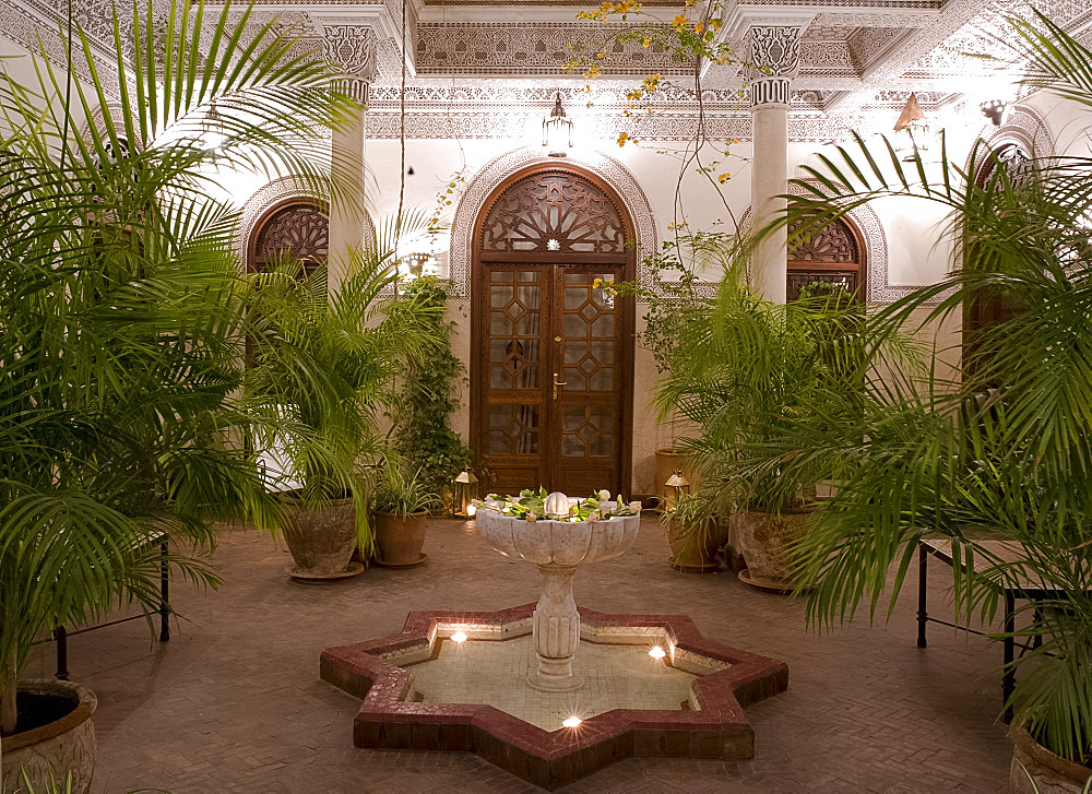 An interior courtyard featuring a marble fountain and palm trees at the Villa des Orangiers in Marrakech, Morocco, North Africa, Africa