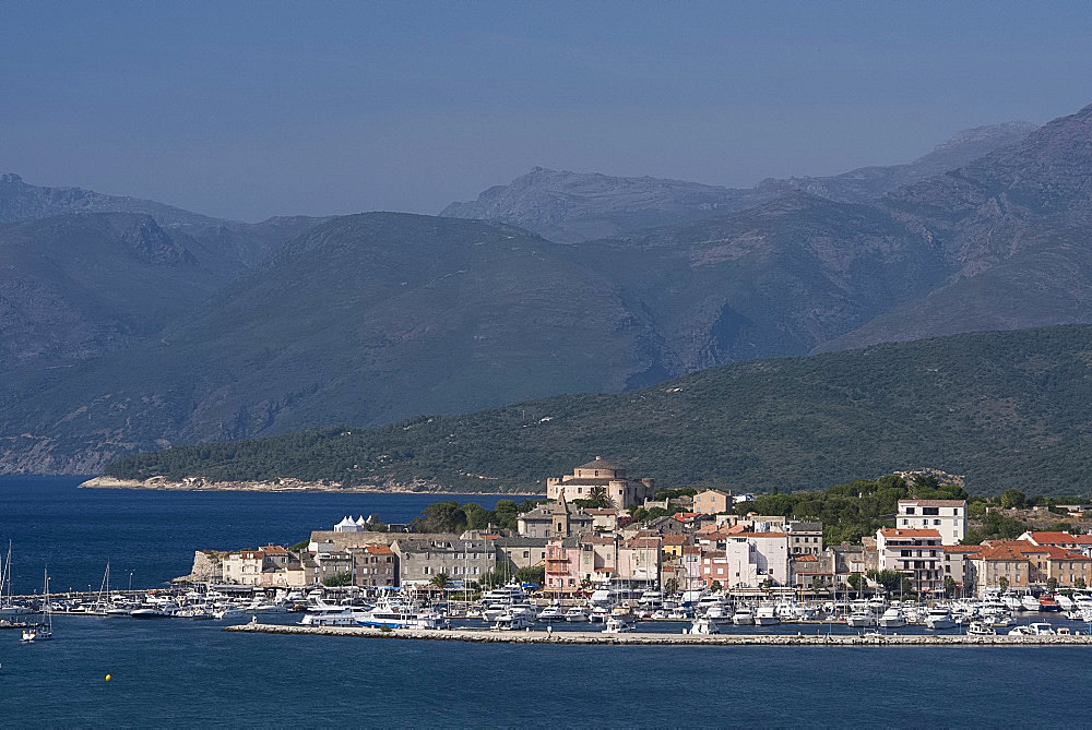 A view of St. Florent and distant mountains in the Nebbio region of nothern Corsica, France, Mediterranean, Europe