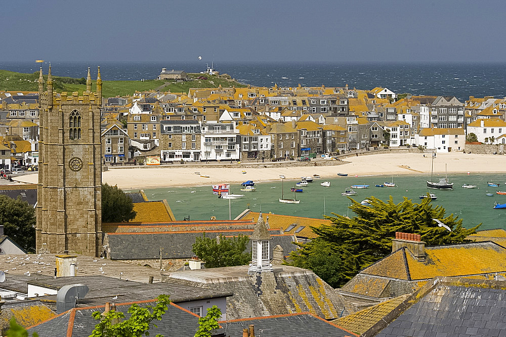 A view over the lichen covered stone rooftops and harbour in St. Ives, Cornwall, England, United Kingdom, Europe