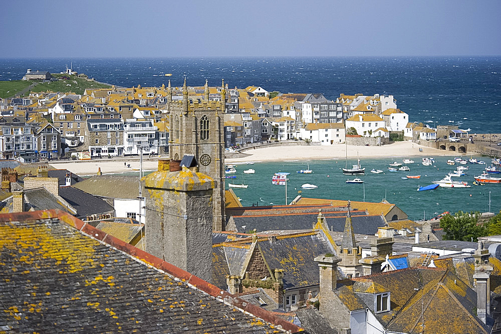 A view over the lichen covered stone rooftops and harbour in St. Ives, Cornwall, England, United Kingdom, Europe