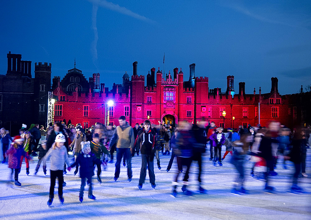 A skating rink in front of Hampton Court Palace lit with red lights, Greater London, England, United Kingdom, Europe