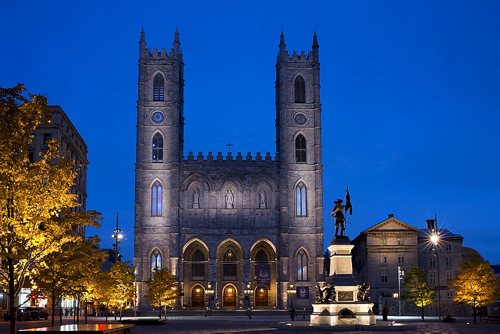 The Notre Dame Cathedral at dusk in the Place d'Arms, Montreal, Quebec Province, Canada, North America