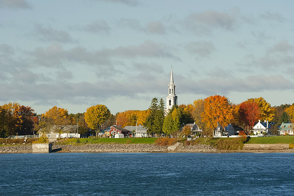 An old village with a church steeple along the St. Lawrence River in Quebec Province, Canada, North America