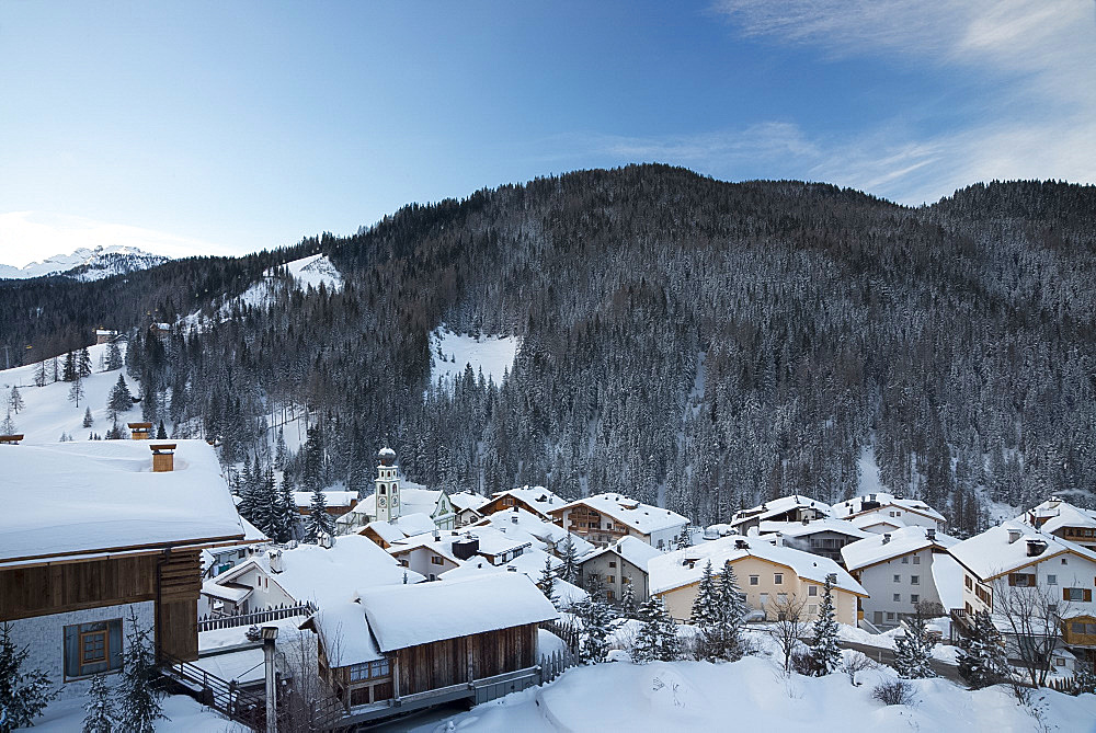 An early morning view of snow covered rooftops in San Cassiano near the Alta Badia ski area, Dolomites, South Tyrol, Italy, Europe