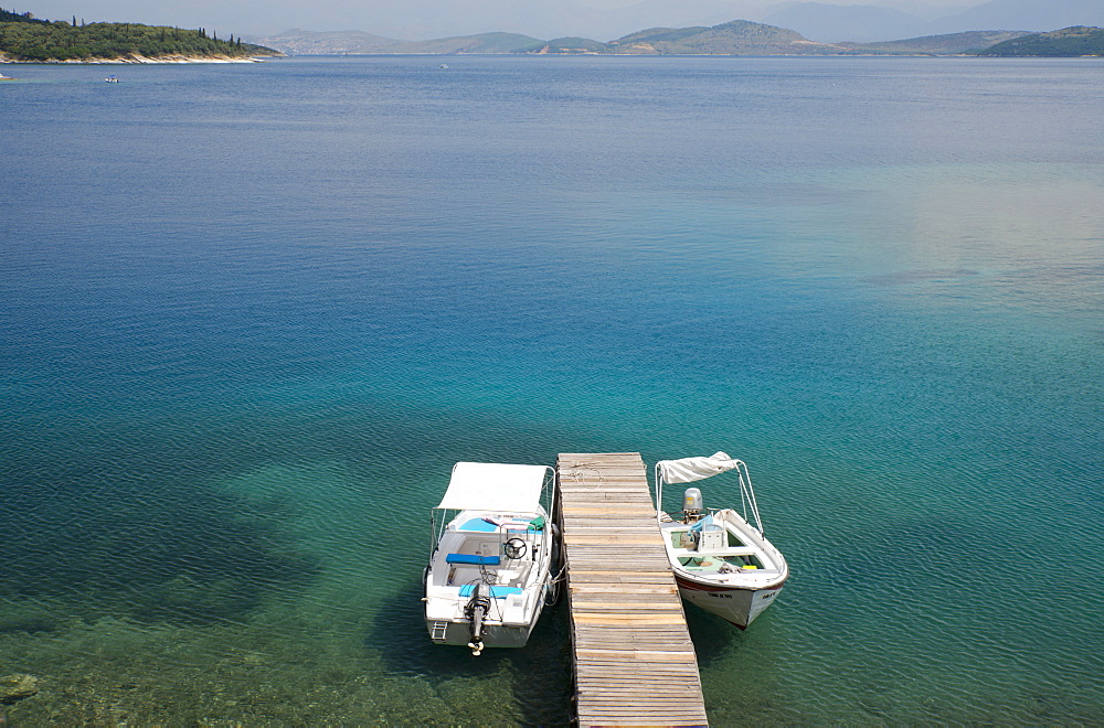 Speedboats tied up at a dock in Kouloura Harbour on the northeast coast of Corfu, Ionian Islands, Greek Islands, Greece, Europe