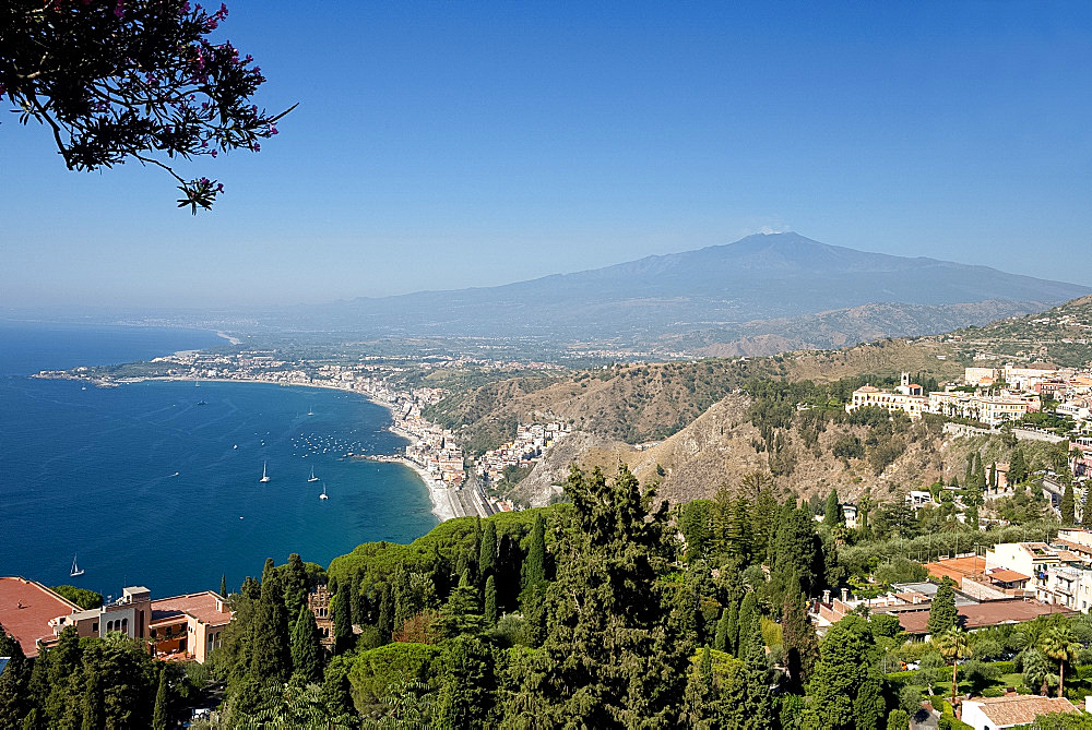 A view to Mount Etna and Naxos Bay on the Ionian Sea from the Greek Theatre in Taormina, Sicily, Italy, Mediterranean, Europe