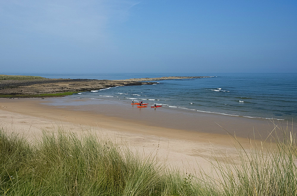 Kayakers on the beach at Football Hole near Low Newton-by-the-Sea, Northumberland, England, United Kingdom, Europe