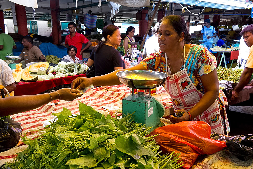 A woman selling vegetables in the market in Mahebourg in Mauritius, The Indian Ocean, Africa