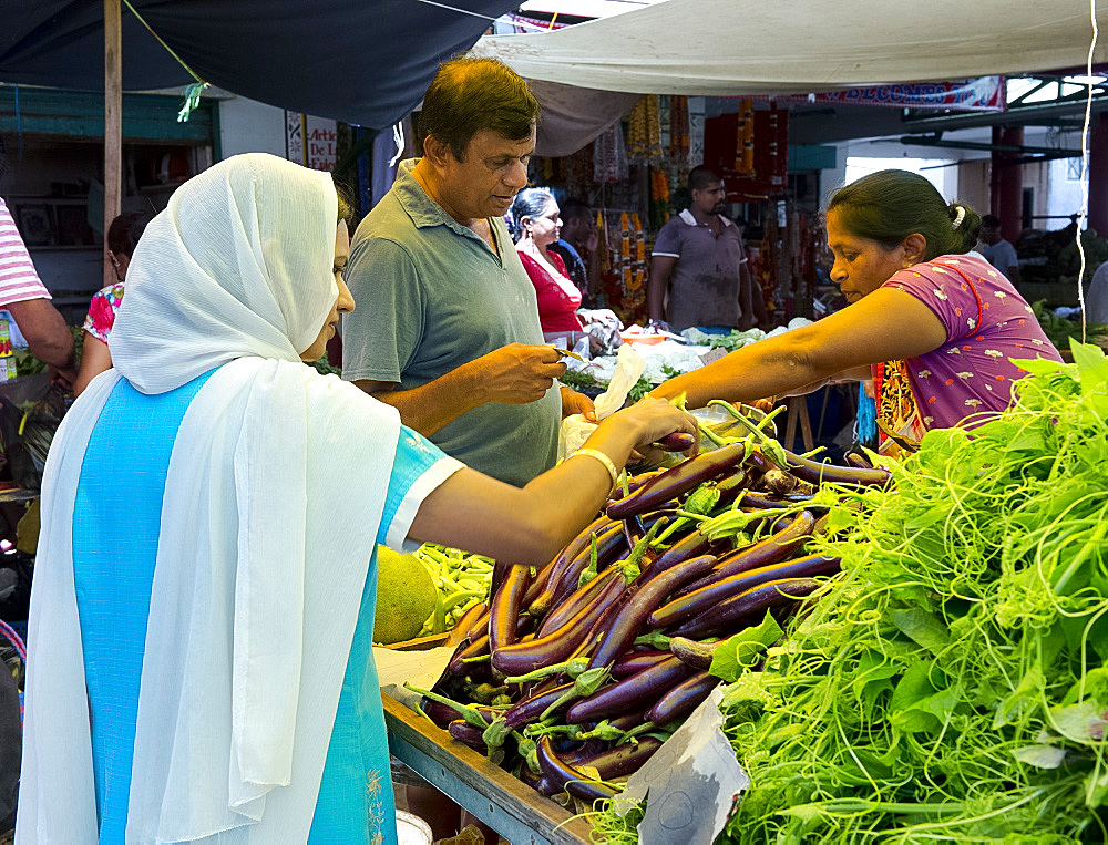 A woman wearing a head scarf shopping in the market in Mahebourg, Mauritius, The Indian Ocean, Africa