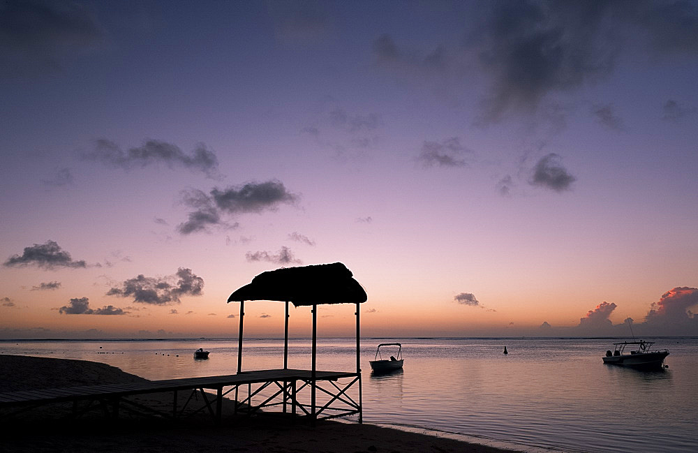 A pier at sunset on the beach of the St. Regis Hotel on Le Morne Brabant Peninisula, south west coast of Mauritius, Indian Ocean, Africa