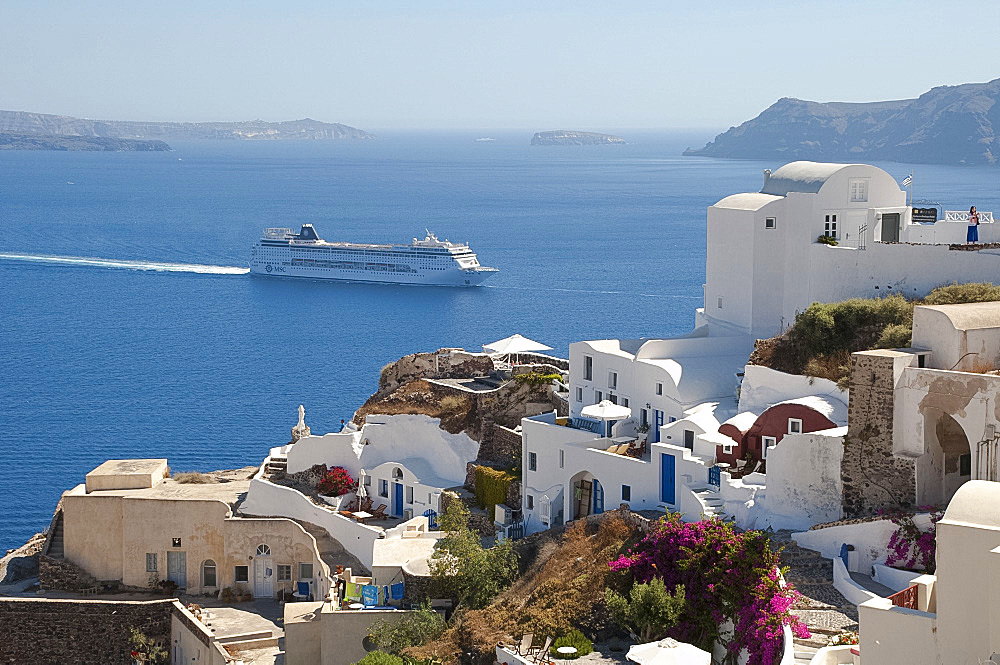 A large cruise ship off the island of Santorini, The Cyclades, Greek Islands, Greece, Europe