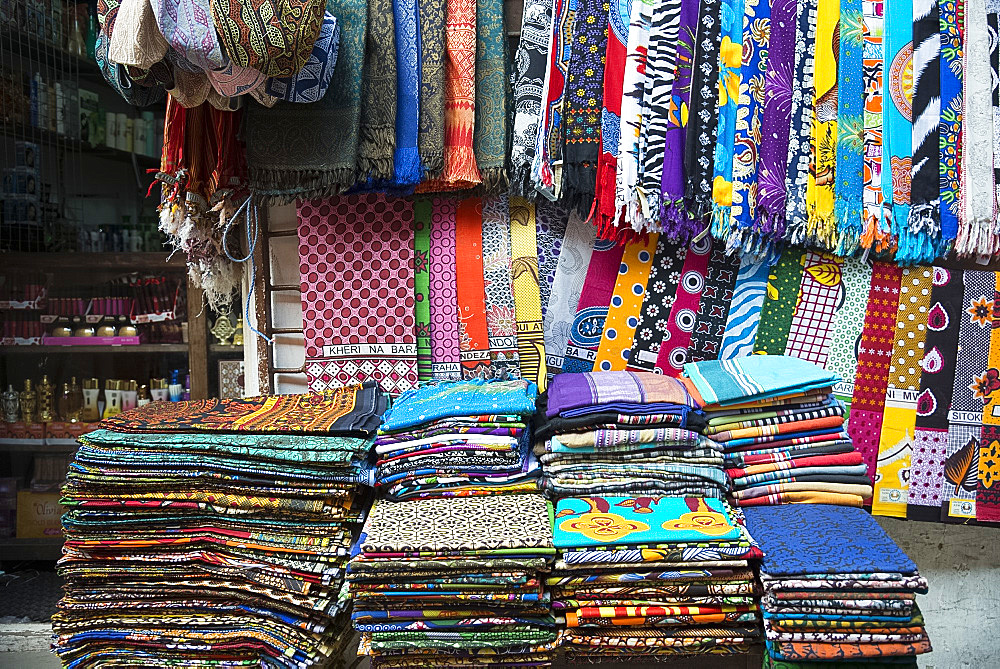 Colourful African fabrics on display in the market in Stone Town, Zanzibar, Tanzania, East Africa, Africa