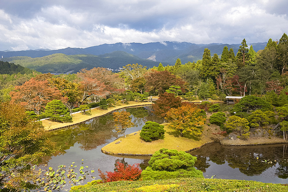 An aerial view of Yokuryuchi Pond surrounded by autumn foliage at the Shugakin Imperial Villa Garden, Kyoto, Japan, Asia