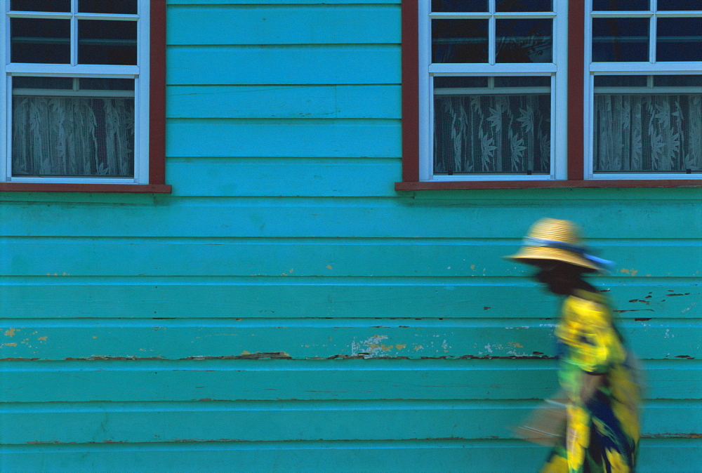 Woman walking in Anse La Raye, St. Lucia, Windward Islands, West Indies, Caribbean, Central America