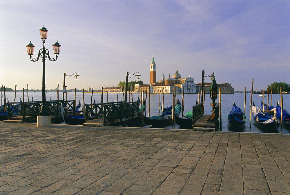 Gondolas moored with the island of San Giorgio Maggiore beyond, Venice, Veneto, Italy, Europe