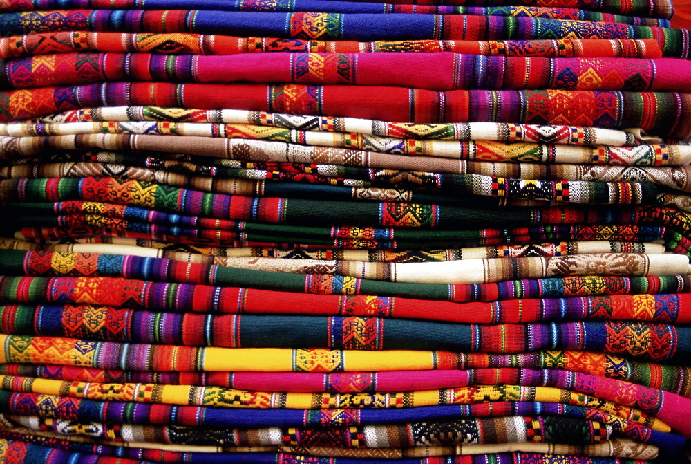 Detail of a pile of colourful ponchos, Cuzco (Cusco), Peru, South America