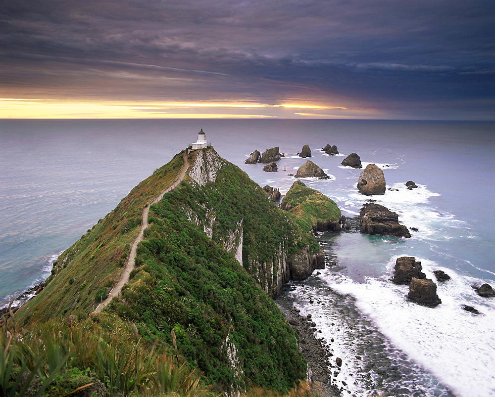 Nugget Point lighthouse on the coast and overcast sky, the Catlins, South Island, New Zealand, Pacific