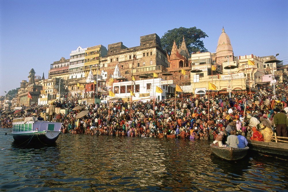 Hindu pilgrims bathing in the early morning in the holy river Ganges (Ganga) along Dasaswamedh Ghat, Varanasi (Benares), Uttar Pradesh state, India, Asia