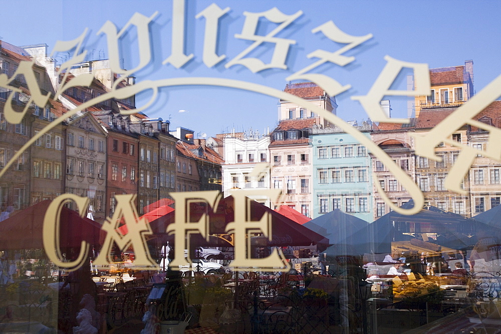 Colourful houses of the Old Town Square (Rynek Starego Miasto) reflected in a cafe window, Old Town (Stare Miasto), UNESCO World Heritage Site, Warsaw, Poland, Europe