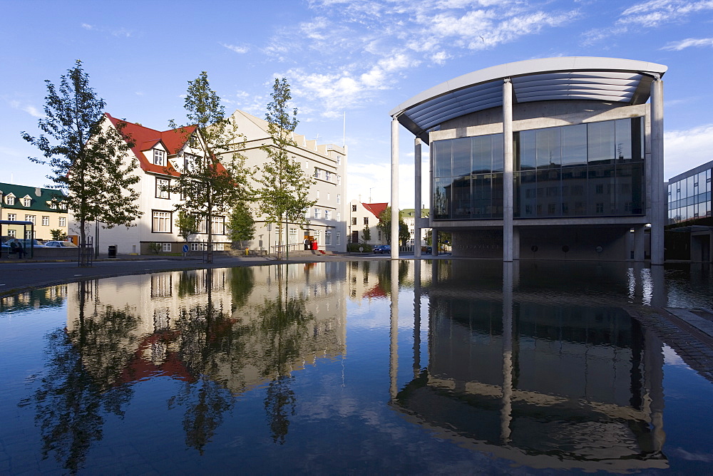 The Radhus (City Hall), an angular construction of concrete, glass and carved lava, Lake Tjorn, Central area, Reykjavik, Iceland, Polar Regions