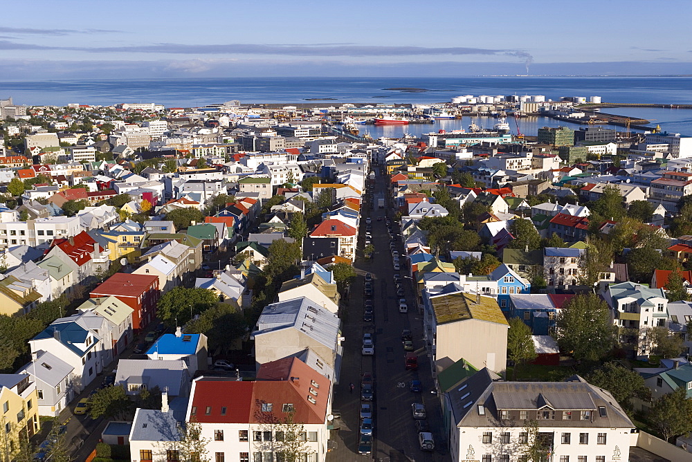 Low aerial view from Hallgrimskirkja of colourful houses, commercial buildings and harbour of the capital city, Reykjavik, Iceland, Polar Regions