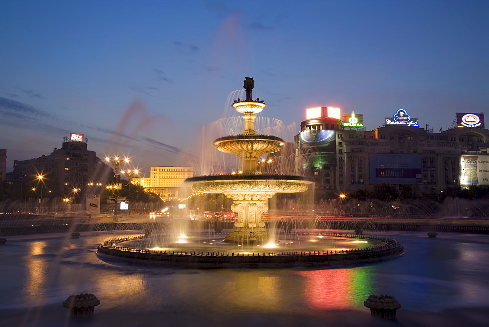 Piata Unirii fountain with the Palace of Parliament building behind, Piata Unirii, Bucharest, Romania, Europe