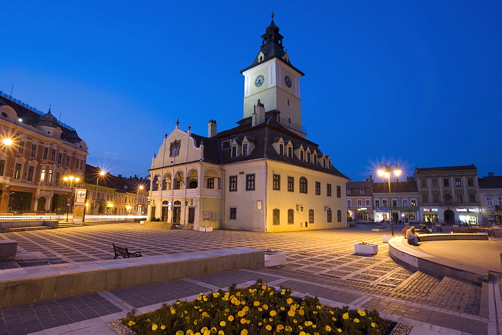 The Council House (Casa Sfatului) dating from 1420 topped by a Trumpeter's Tower, the old city hall now houses the Brasov Historical Museum, illuminated at dusk, Piata Sfatului, Brasov, Transylvania, Romania, Europe