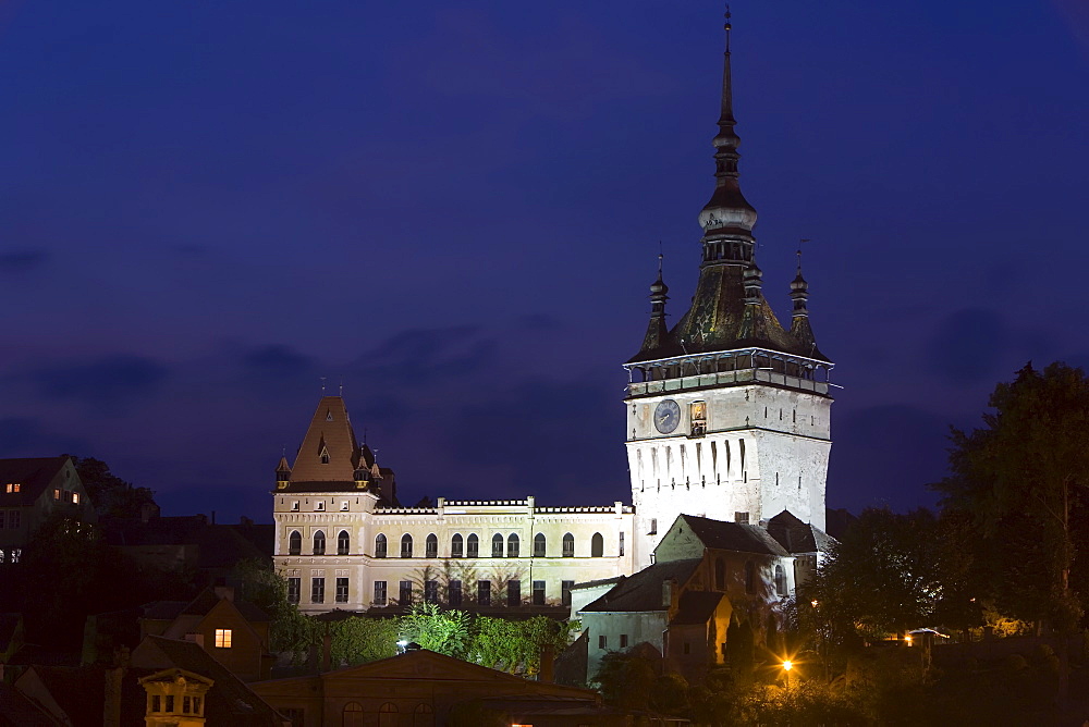 Clock tower (Turnul cu Ceas), illuminated at dusk, formerly the main entrance to the fortified city, in the medieval old town or citadel, Sighisoara, UNESCO World Heritage Site, Transylvania, Romania, Europe