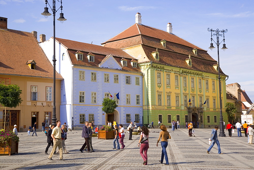 Colourfully painted houses and buildings surrounding the main old town square, Piata Mare, in the 12th century Saxon city, Sibiu, Transylvania, Romania, Europe